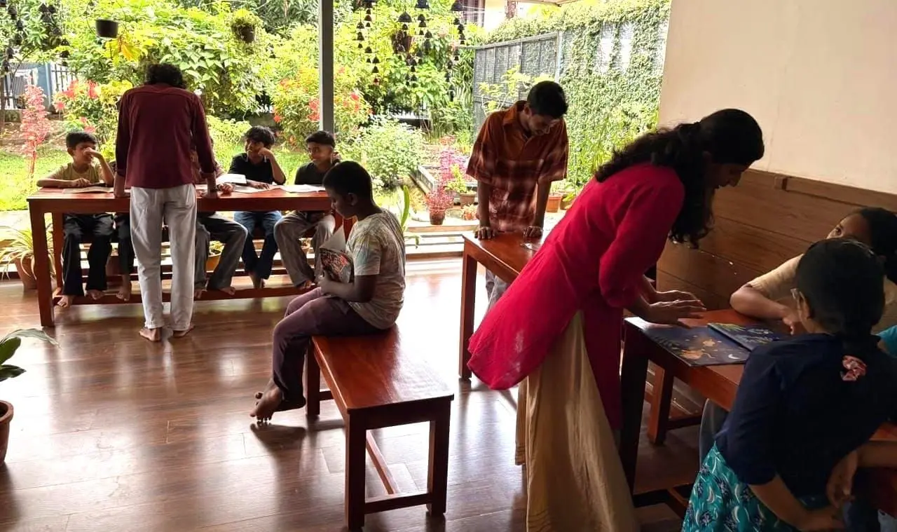 Children read together with volunteers at the Reading Club